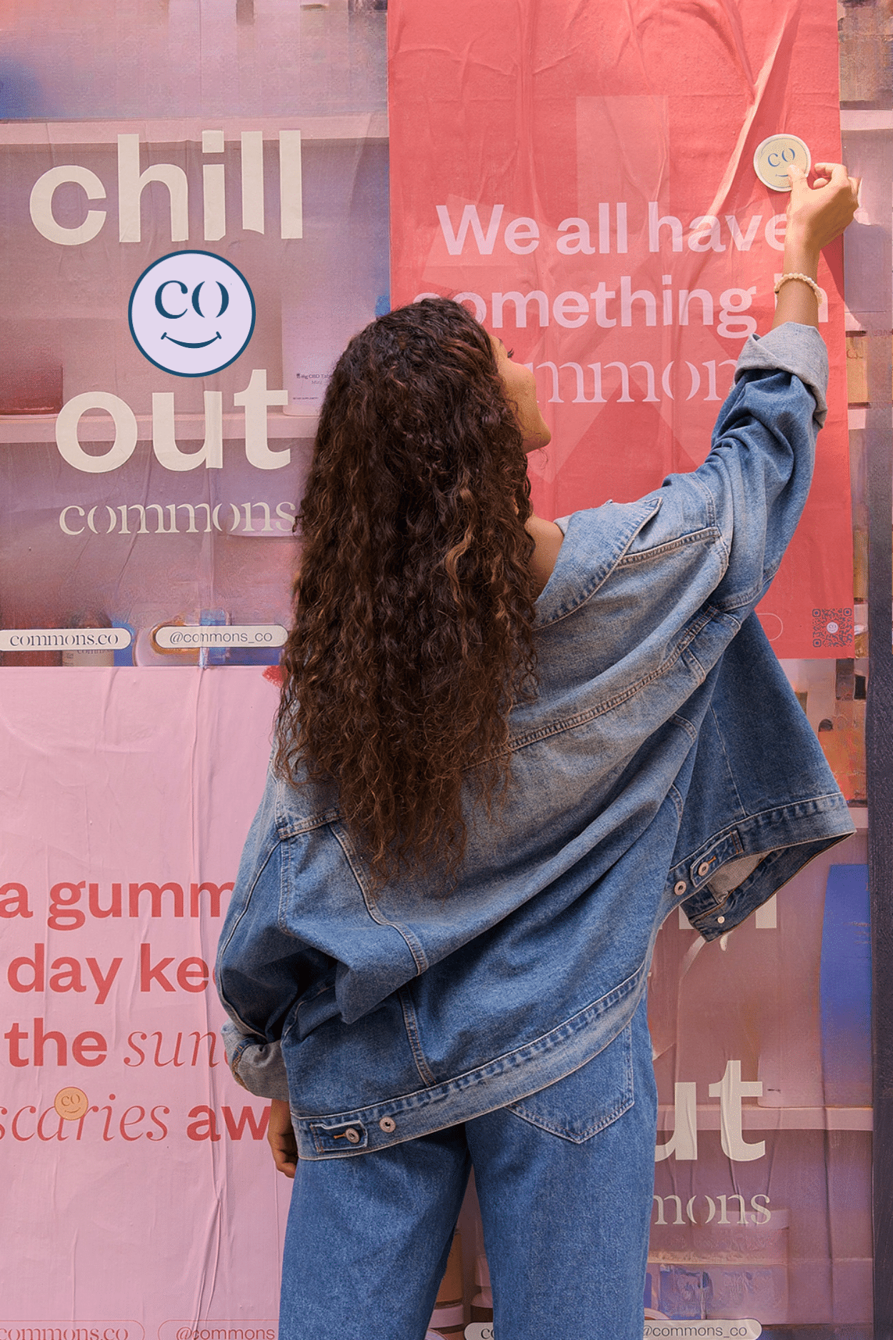 lady placing sticker on poster